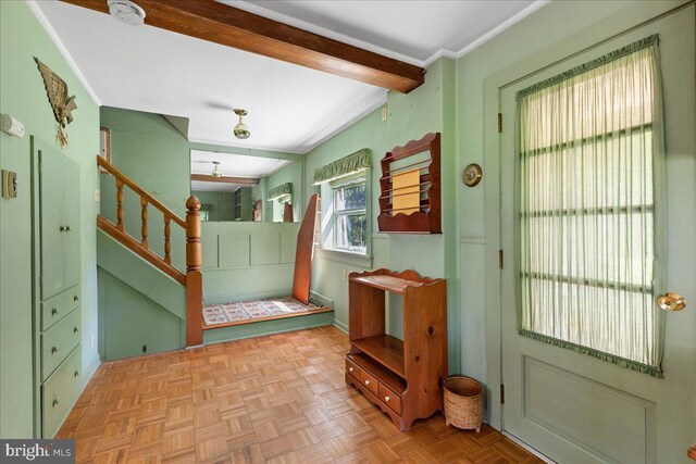 entryway with beam ceiling and light parquet floors