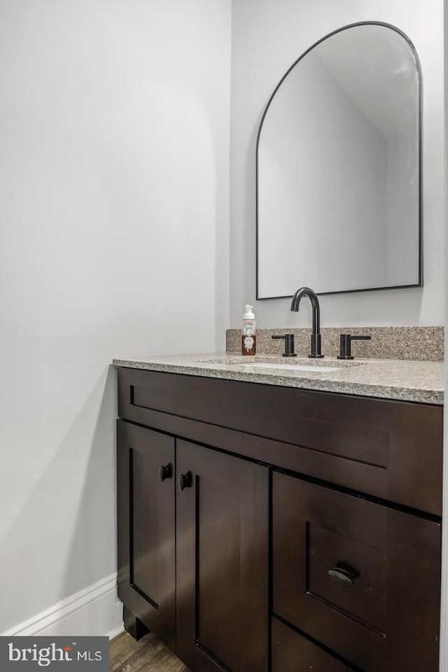 bathroom featuring vanity and hardwood / wood-style flooring