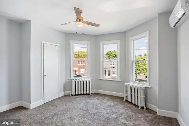 carpeted spare room with ceiling fan, radiator, and a wall mounted air conditioner