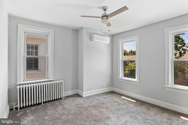 empty room with ceiling fan, a wall unit AC, radiator, and light carpet