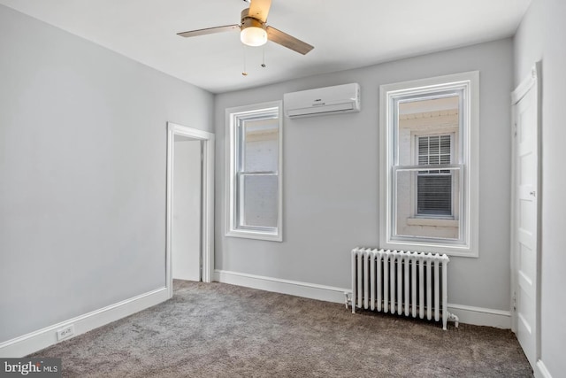 unfurnished bedroom with multiple windows, ceiling fan, a wall unit AC, and radiator heating unit