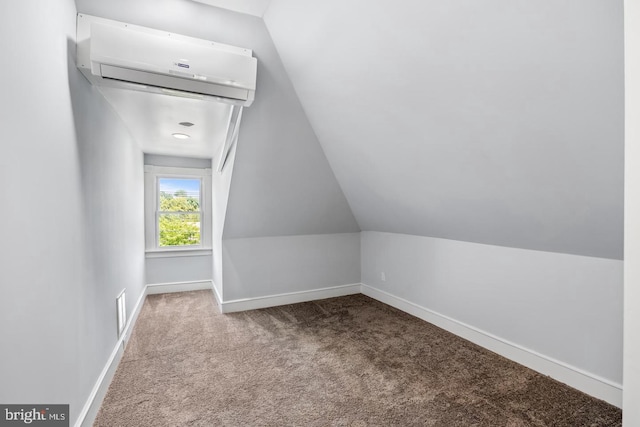 additional living space with carpet flooring, a wall mounted air conditioner, and vaulted ceiling