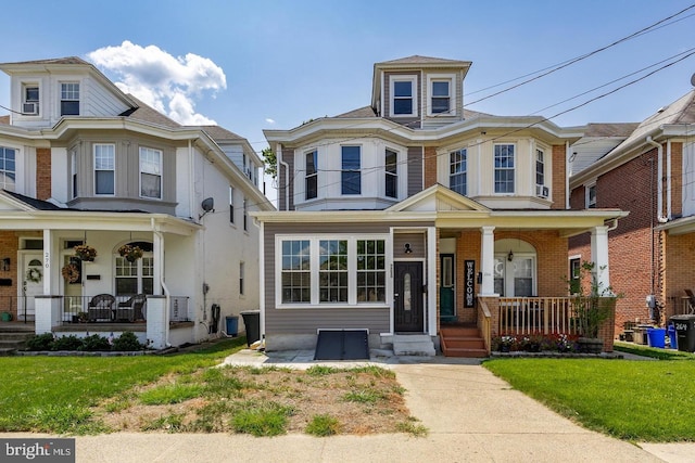 view of front of property featuring a front yard and a porch