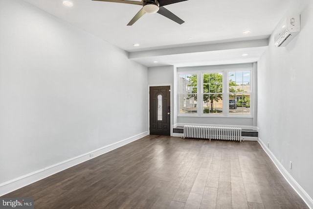 interior space featuring ceiling fan, dark hardwood / wood-style floors, radiator heating unit, and a wall unit AC