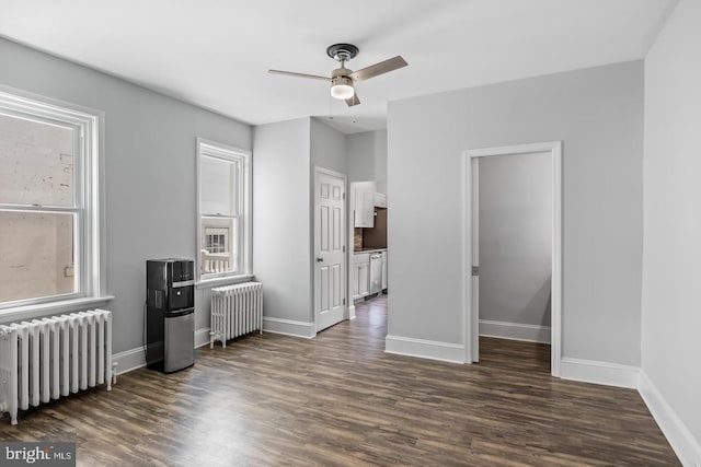 living room featuring radiator heating unit, dark wood-type flooring, and ceiling fan