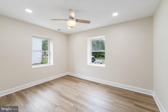 unfurnished room with light wood-type flooring, ceiling fan, and plenty of natural light