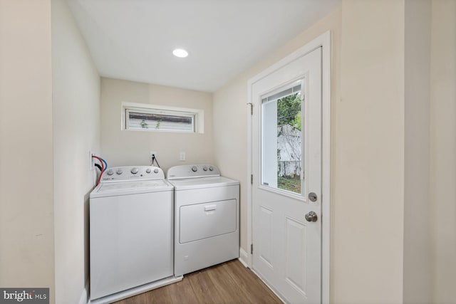 laundry area featuring light hardwood / wood-style flooring and washer and clothes dryer