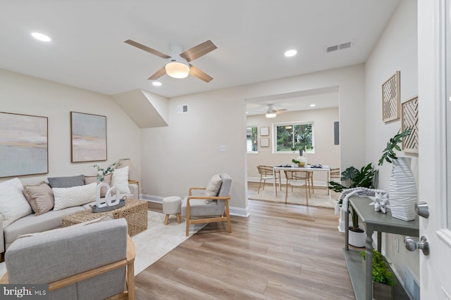 living room with light hardwood / wood-style floors and ceiling fan