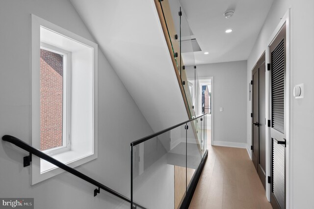 hallway with light hardwood / wood-style floors