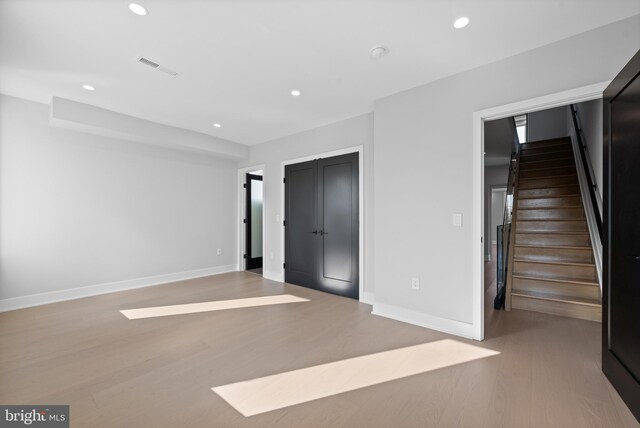 unfurnished bedroom with a closet and light wood-type flooring