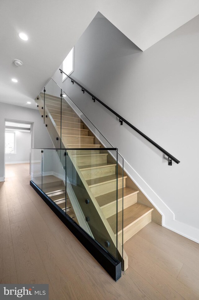 stairs featuring hardwood / wood-style floors