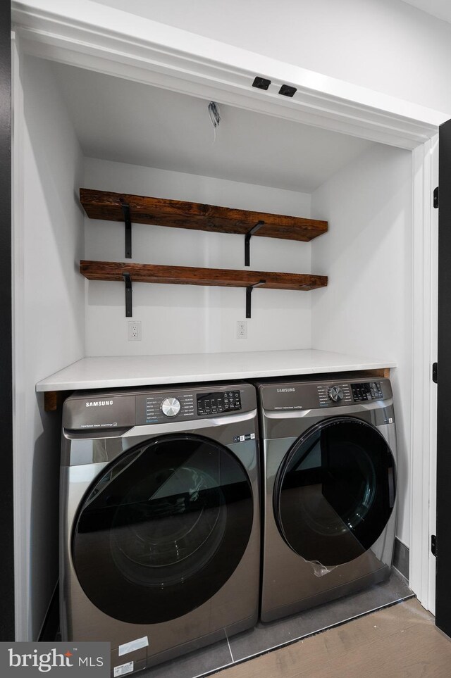 washroom featuring washer and clothes dryer