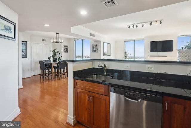 kitchen with decorative light fixtures, dishwasher, light hardwood / wood-style flooring, sink, and a chandelier