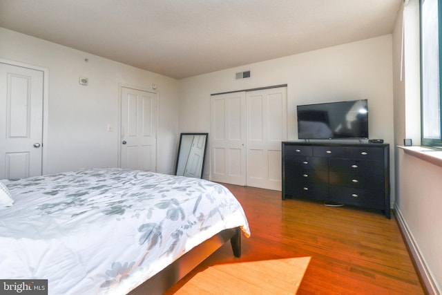 bedroom with dark wood-type flooring