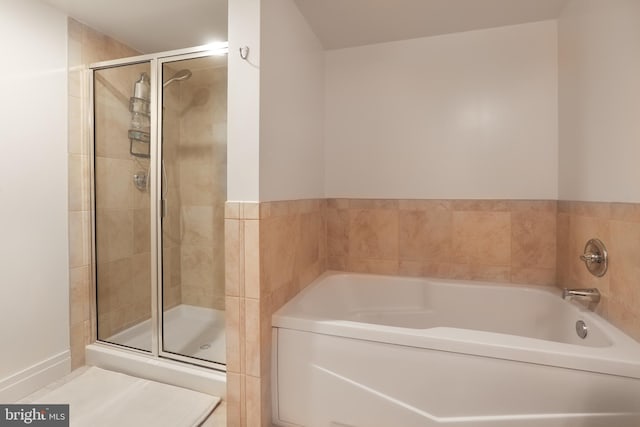 bathroom with separate shower and tub