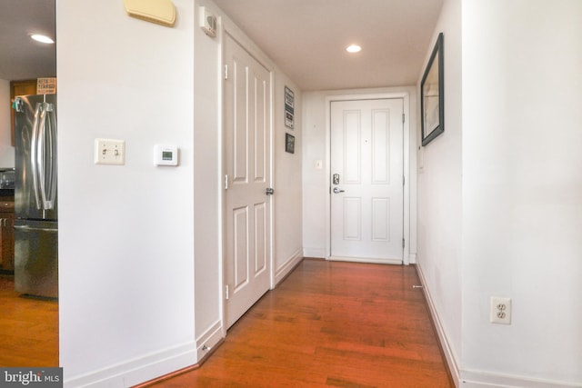 corridor featuring dark hardwood / wood-style floors