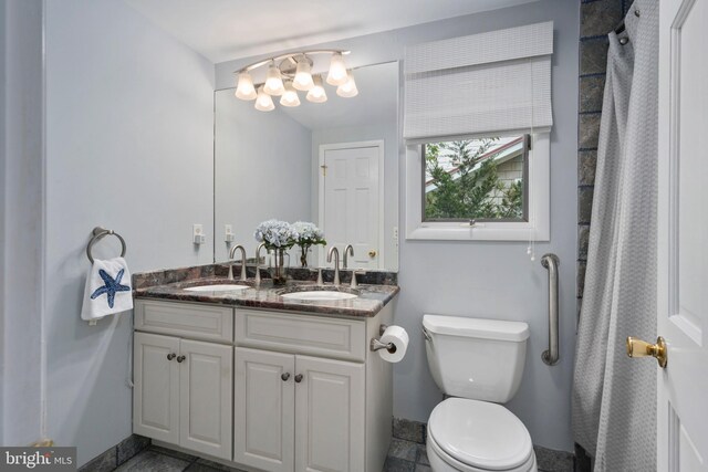 bathroom with vanity, a chandelier, toilet, and tile patterned floors