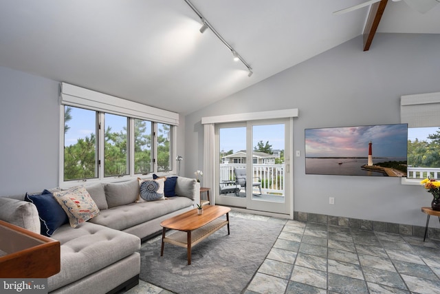 living room featuring vaulted ceiling with beams, ceiling fan, and track lighting