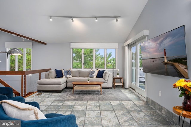 living room featuring vaulted ceiling and a wealth of natural light