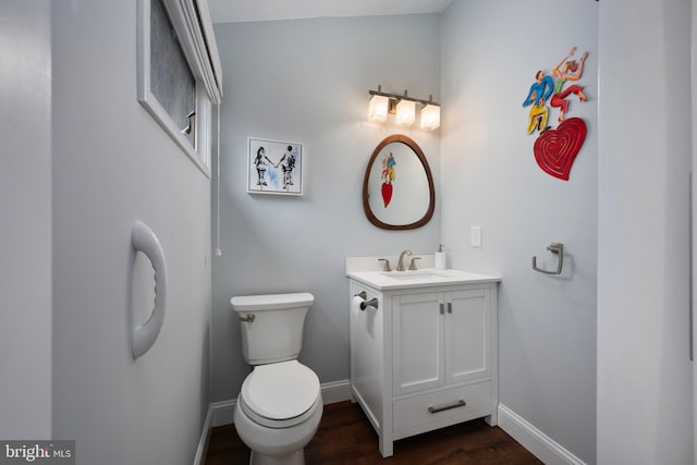 bathroom featuring vanity, toilet, and hardwood / wood-style flooring