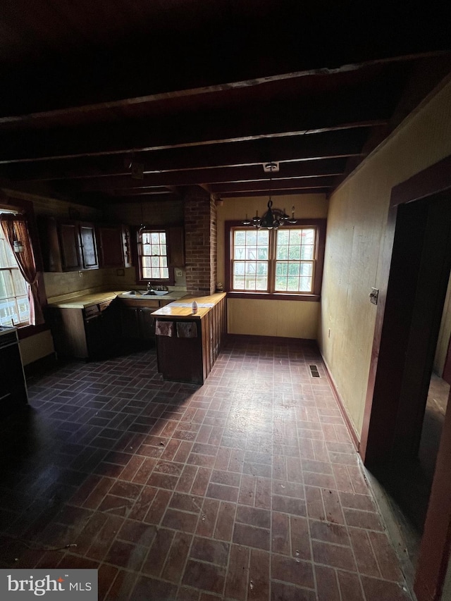 kitchen featuring a center island, an inviting chandelier, and sink