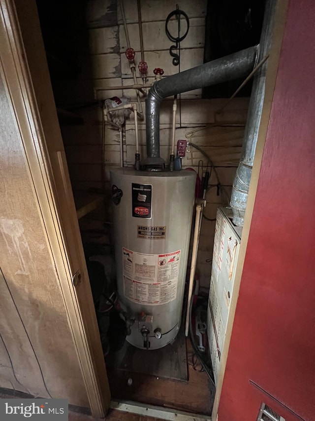 utility room featuring water heater