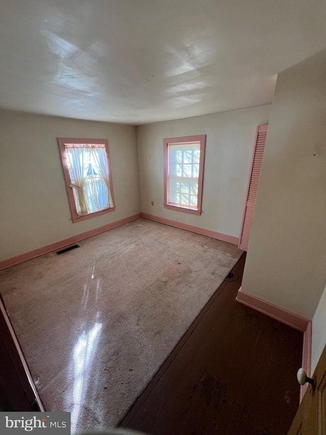 unfurnished room featuring light carpet