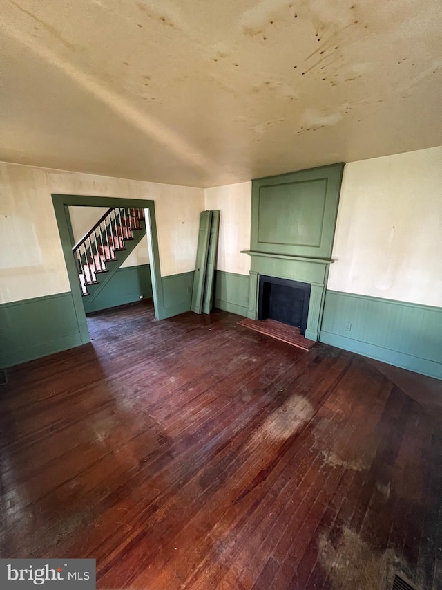 unfurnished living room with dark hardwood / wood-style flooring