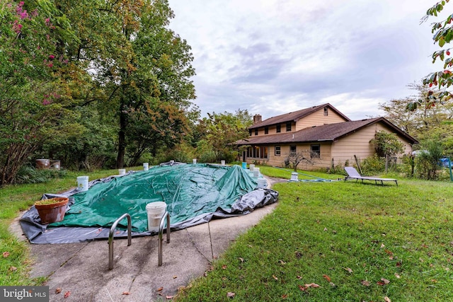 view of pool featuring a lawn