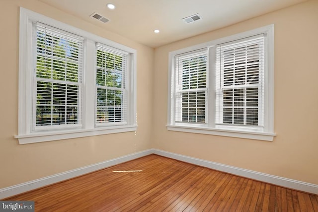 unfurnished room featuring hardwood / wood-style flooring