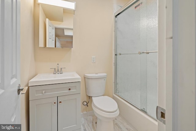 full bathroom with vanity, toilet, and enclosed tub / shower combo