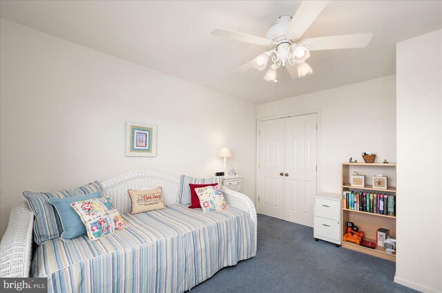 carpeted bedroom featuring ceiling fan and a closet