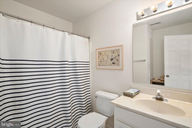 bathroom featuring toilet and vanity