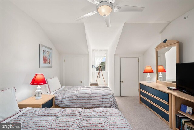 carpeted bedroom with lofted ceiling and ceiling fan