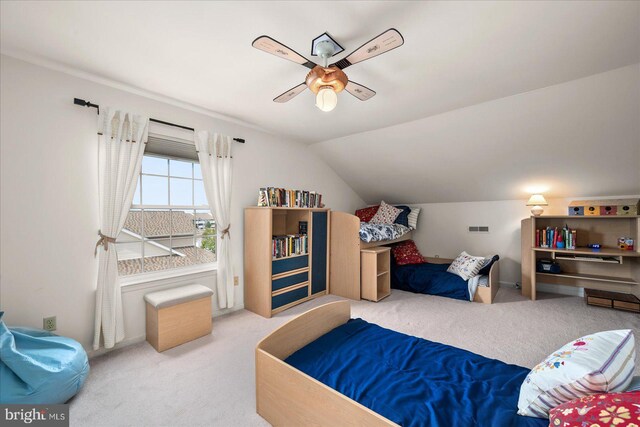 bedroom featuring lofted ceiling, ceiling fan, and carpet