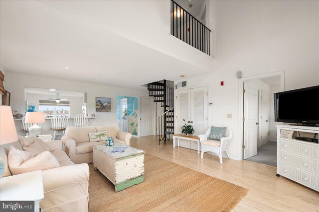 living room with ceiling fan and hardwood / wood-style flooring