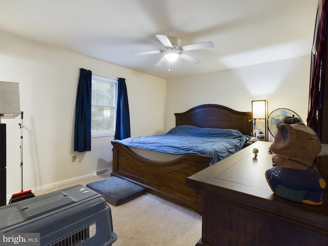 carpeted bedroom featuring baseboards, a ceiling fan, and visible vents