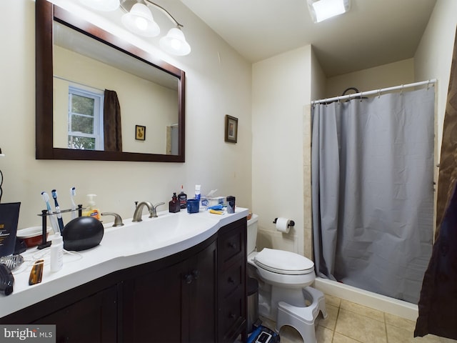 bathroom featuring toilet, tile patterned flooring, vanity, and walk in shower