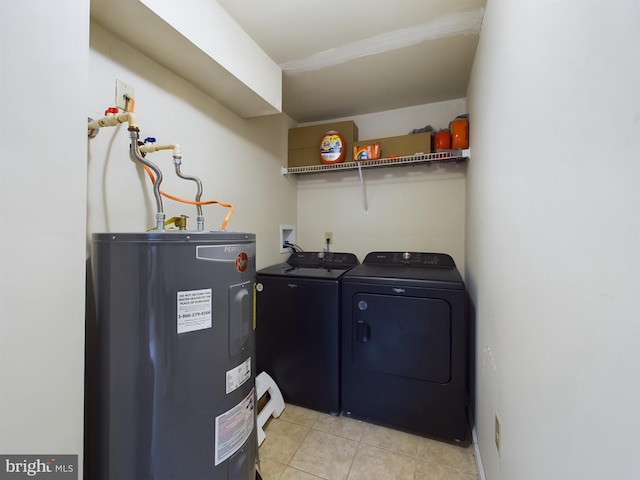 laundry room featuring independent washer and dryer, water heater, and light tile patterned floors