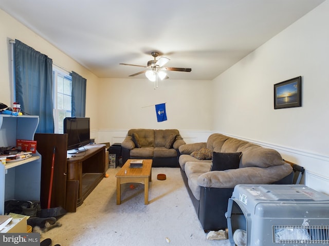 carpeted living room with ceiling fan