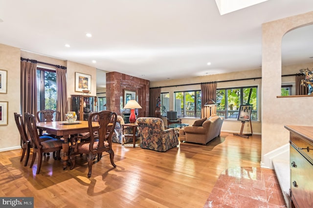 dining area with recessed lighting, a healthy amount of sunlight, light wood-style flooring, and baseboards