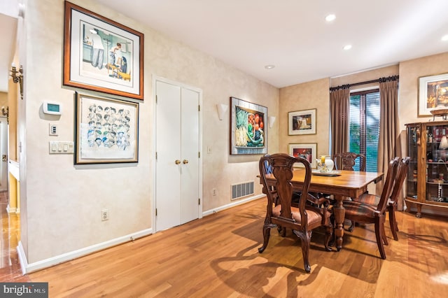 dining space with recessed lighting, visible vents, wood finished floors, and baseboards