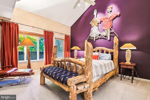 bedroom with ceiling fan, vaulted ceiling, and carpet floors