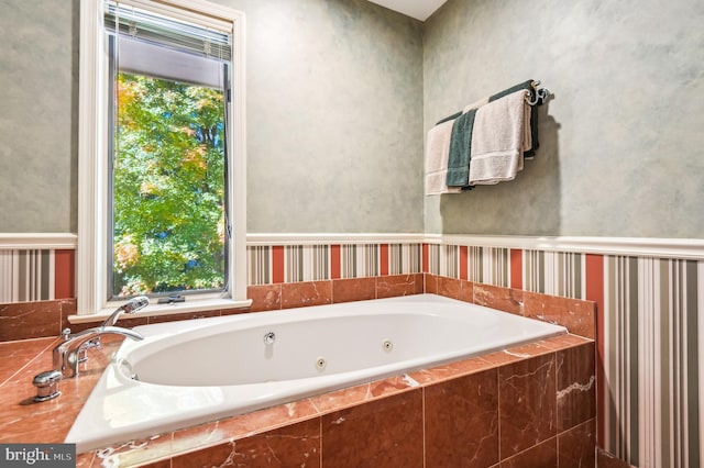 bathroom with a relaxing tiled tub