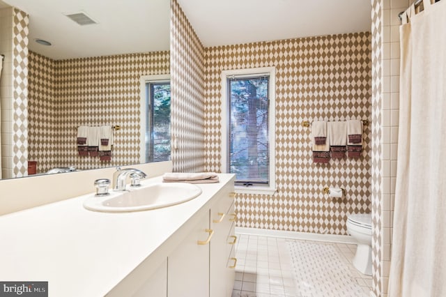 bathroom featuring visible vents, wallpapered walls, toilet, tile patterned floors, and vanity