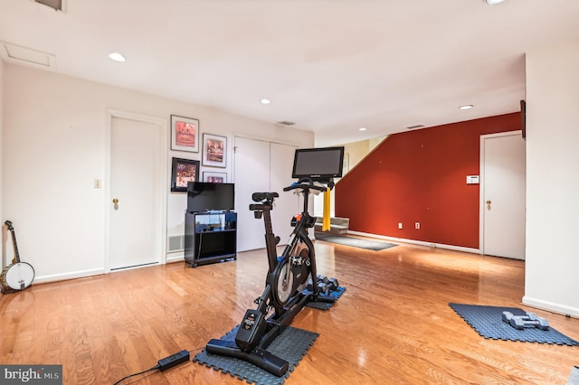 workout area with recessed lighting, wood finished floors, and baseboards