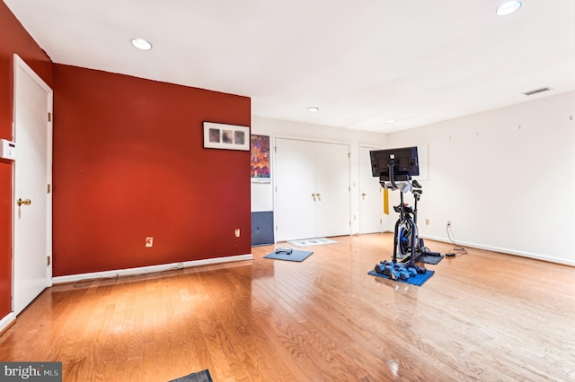 workout area with recessed lighting, wood finished floors, and baseboards