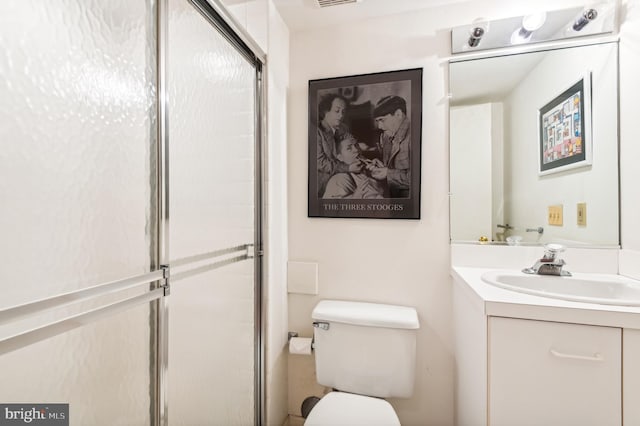 full bathroom with toilet, a shower with shower door, and vanity