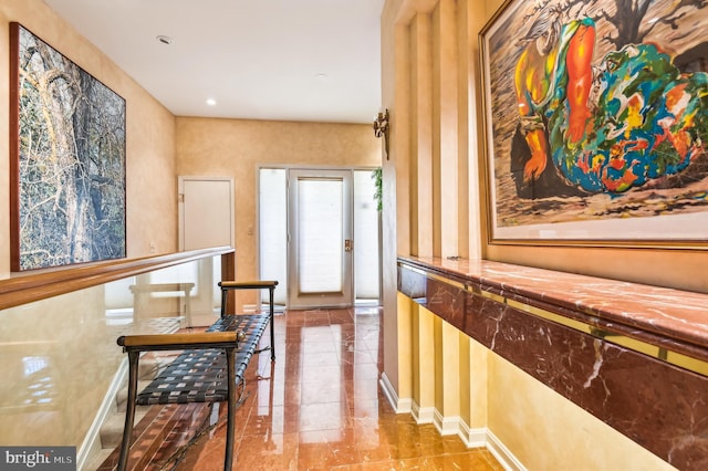 corridor with baseboards and wallpapered walls
