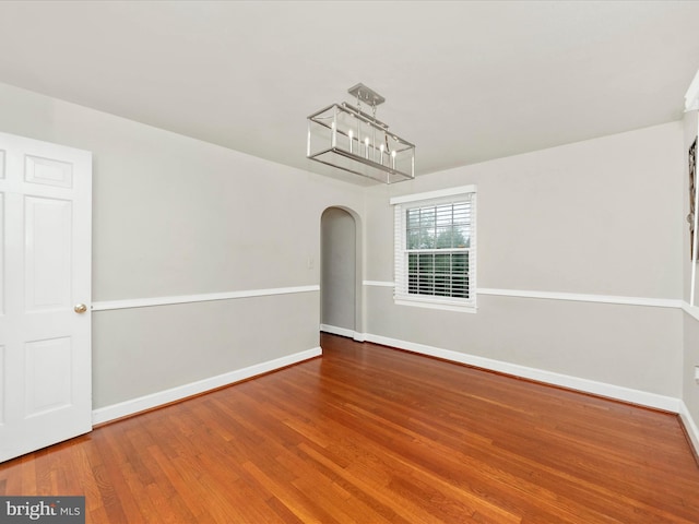 unfurnished room with wood-type flooring